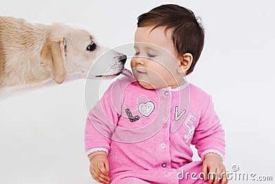 Dog licking baby face Stock Photo
