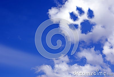 Dog paw trail in the sky clouds Stock Photo