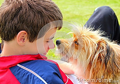 Dog sniffing the boys face Stock Photo