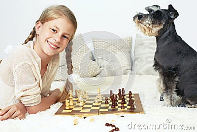 The dog teaches the child to play chess. Your move Stock Photo