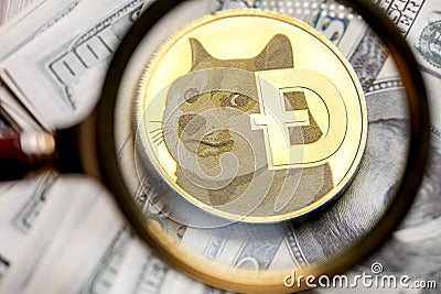 Dogecoin cryptocurrency coin under a magnifying glass Editorial Stock Photo