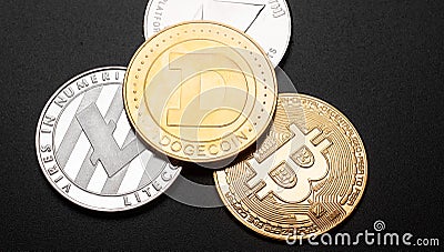 dogecoin on top above bitcoin, litecoin, ether cutout on black background Editorial Stock Photo