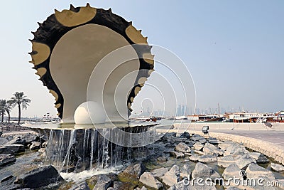 The Pearl Monument on the Doha corniche, with traditional dhows and the skyscrapers of the West Editorial Stock Photo