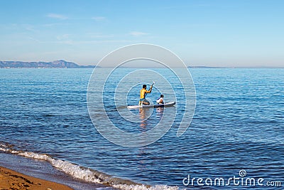 Doing paddle surfing in family with a small child Editorial Stock Photo