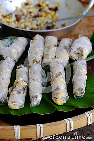 Doing Vietnamese vegetarian dish, make deep fried corn spring roll, vegan food in leaf background Stock Photo