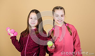 Doing whatever they want. Sport success. gym workout of teen girls. Tennis racket and ball for activity. Little girl Stock Photo