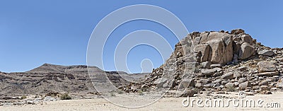Dolerite boulder butte and hills with layers of conglomerate in desert, near Hobas, Namibia Stock Photo