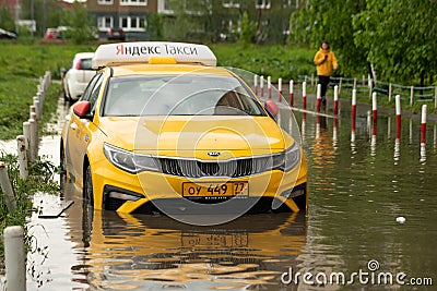 Yellow taxi vehicle stuck in flooded road Editorial Stock Photo