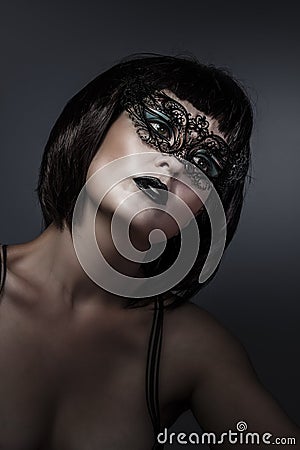 Doll, beautiful brunette with short hair and Venetian mask, cabaret Stock Photo