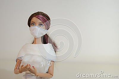 Doll with face mask and hospital supplies closeup on white background Editorial Stock Photo