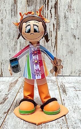 Doll holding a movil Stock Photo