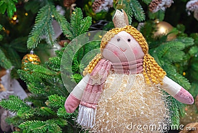 Doll princess with a crown on the background of the Christmas tree Stock Photo