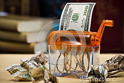 Dollar banknote in a paper shredder Stock Photo