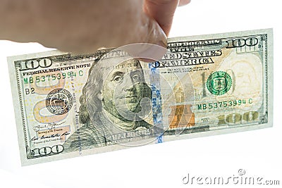 100 dollar bill in the hand. The reverse side is visible on a gleam. Isolated on a white background Stock Photo