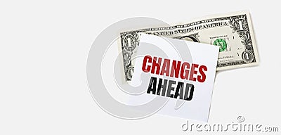 1 dollar bill and white notepad sheet on the white background. CHANGES AHEAD text Stock Photo