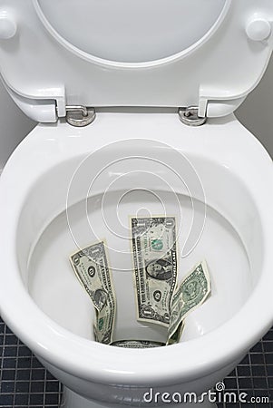 US One Dollar bills flushed down a toilet, toilet paper, worthless, trash Stock Photo