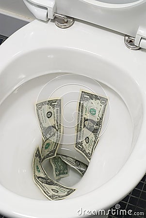 US one dollar bills flushed down the toilet, toilet paper worthless money concept Stock Photo