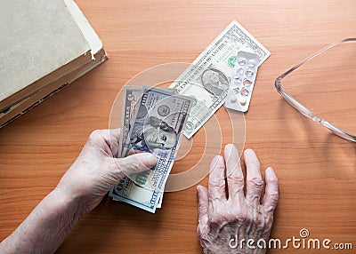 Dollar bills in the hands of a pensioner Stock Photo
