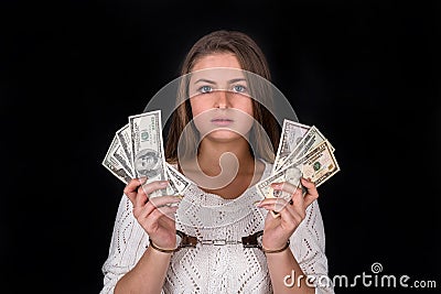 Dollar bribe divided in woman hands in handcuffs Stock Photo