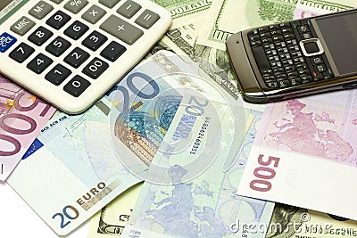 Dollar, euro banknotes, calculator and cellphone Stock Photo