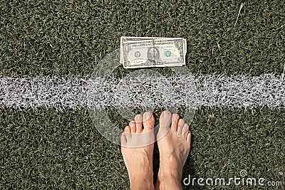 dollar lies near the strip on the grass and near the bare feet of a woman, financial theme, dollar Stock Photo