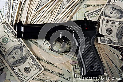 Dollar notes and gun, black pistol Stock Photo