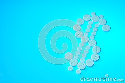 Dollar-shaped pills are on a blue background. White pills on blue background concept Stock Photo