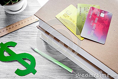 Dollar sign and credit cards for fee-paying education on gray st Stock Photo