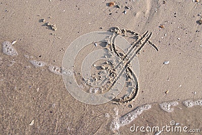 Dollar sign painted on the sand of beach is washed off by a sea Stock Photo
