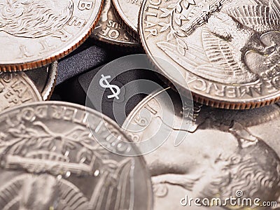 Dollar symbol. American US money quarter coins lie on a black computer or laptop keyboard around a button with a national currency Stock Photo