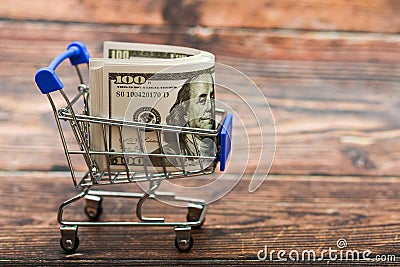 Dollar in a trolley, money in a consumer basket Stock Photo