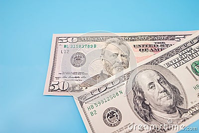 100 and 50 dollars on a blue background Stock Photo