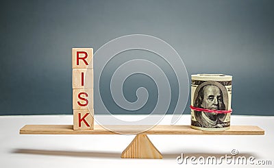 Dollars and the inscription `Risk` on the scales. The concept of financial risk and investing in a business project. Making the ri Stock Photo