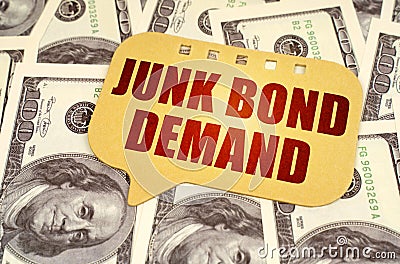 On the dollars is a sign with the inscription - JUNK BOND DEMAND Stock Photo