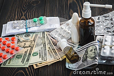 Of dollars on the table on the background of medical AIDS, expensive drugs Stock Photo