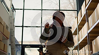 Workers review warehouse inventory Stock Photo