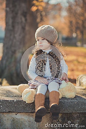 Dolly pin-up toothsome young brunette girl wearing fashion stylish gray jacket jerkin and warm hat with awesome boots clothes posi Stock Photo