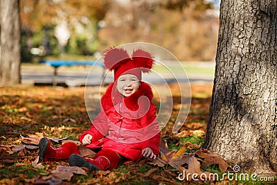 Dolly pin-up toothsome young girl wearing red blushful winter jacket and warm hat with boots fashion stylish clothes posing in aut Stock Photo
