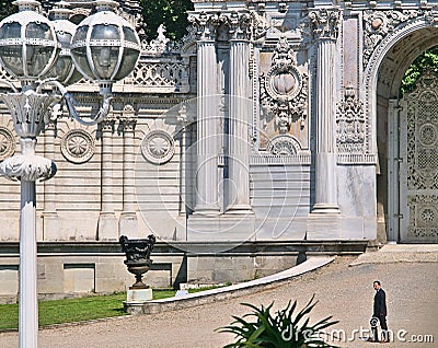 Dolmabahce palace, man in black suit walking in front of impressive entrance Editorial Stock Photo