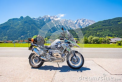 Dolomites Italy - July 2, 2022: Motorcycle with full equipment on the side of a rural mountain alpine road in area of Editorial Stock Photo