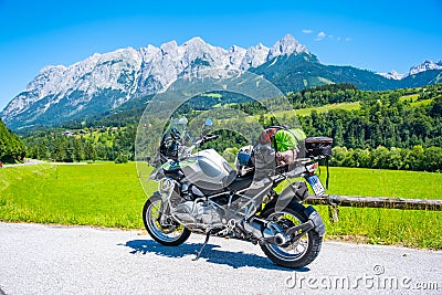 Dolomites Italy - July 2, 2022: Motorcycle with full equipment on the side of a rural mountain alpine road in area of Editorial Stock Photo