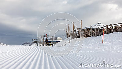 Dolomites, ski area with beautiful slopes. Empty ski slope in winter on a sunny day. Prepare ski slope, Alpe Cermis, Italy Stock Photo