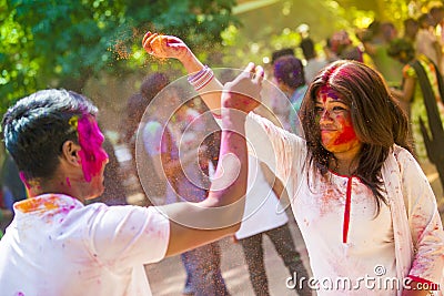 People covered in colorful powder dyes celebrating the Holi Hindu Festival in Dhakah in Bangladesh. Editorial Stock Photo