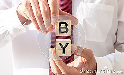 BY domen text on cube blocks in hands of businessman Stock Photo