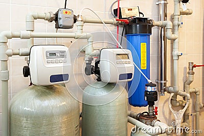 A domestic household boiler room with a new modern solid fuel boiler , heating electric warm water system and pipes. Stock Photo