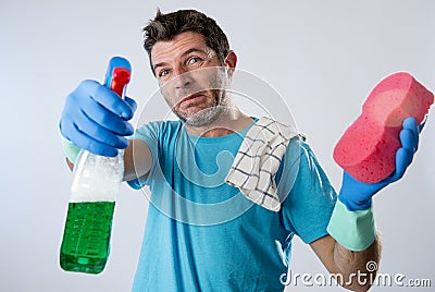 Domestic service man or tired husband angry and stressed house cleaning with spray bottle and sponge Stock Photo