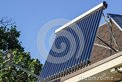 Domestic solar panel on a roof, with clear, cloudless sky Stock Photo