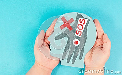 Domestic violence, hand hits face, sos on exclamation mark, international awareness month october for victims and survivors Stock Photo