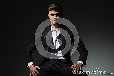 Dominant man in tuxedo with open collar and undone bowtie Stock Photo