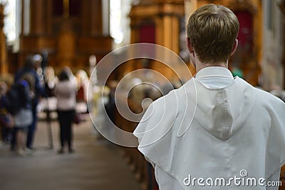 A friar standing at the end of a church Stock Photo